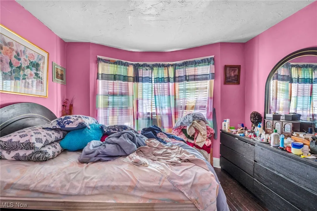 Bedroom featuring multiple windows and a textured ceiling