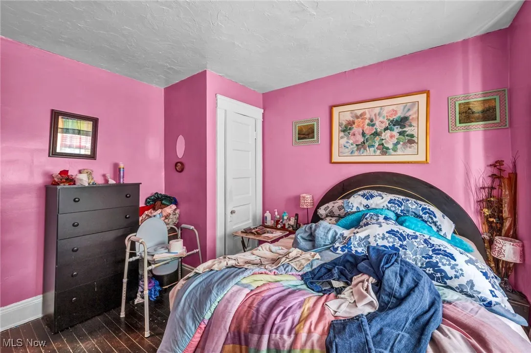 Bedroom featuring baseboards and a textured ceiling