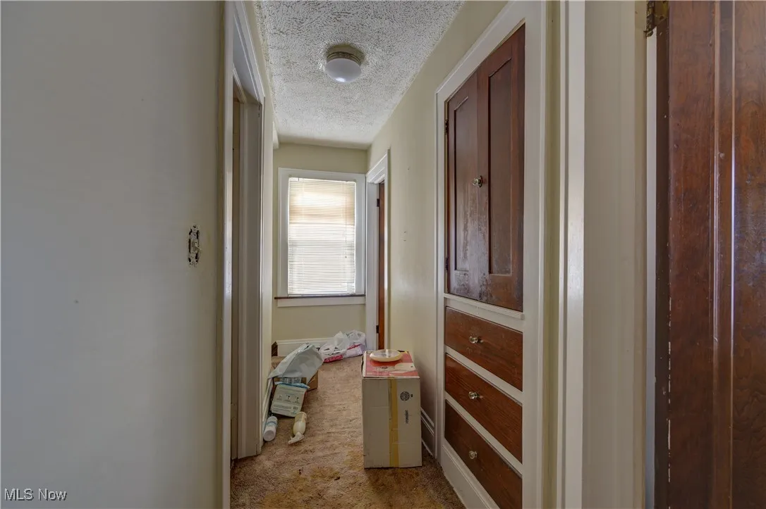 Upstairs Corridor featuring carpet and a textured ceiling