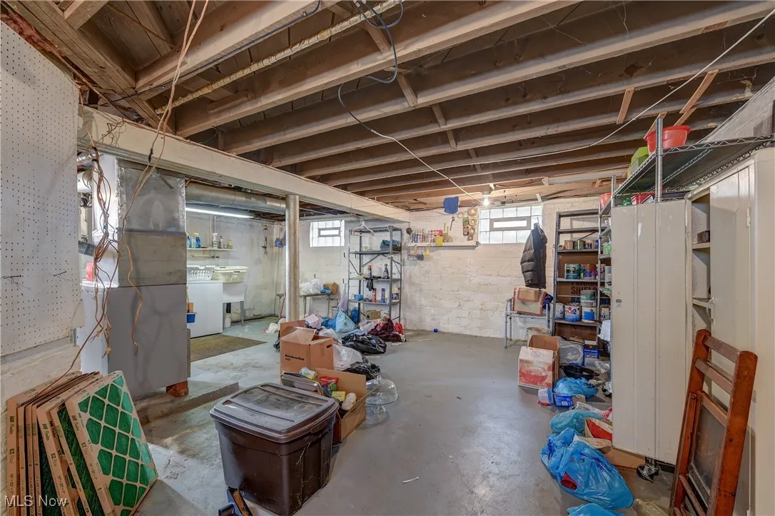 Basement featuring heating unit and washer / dryer