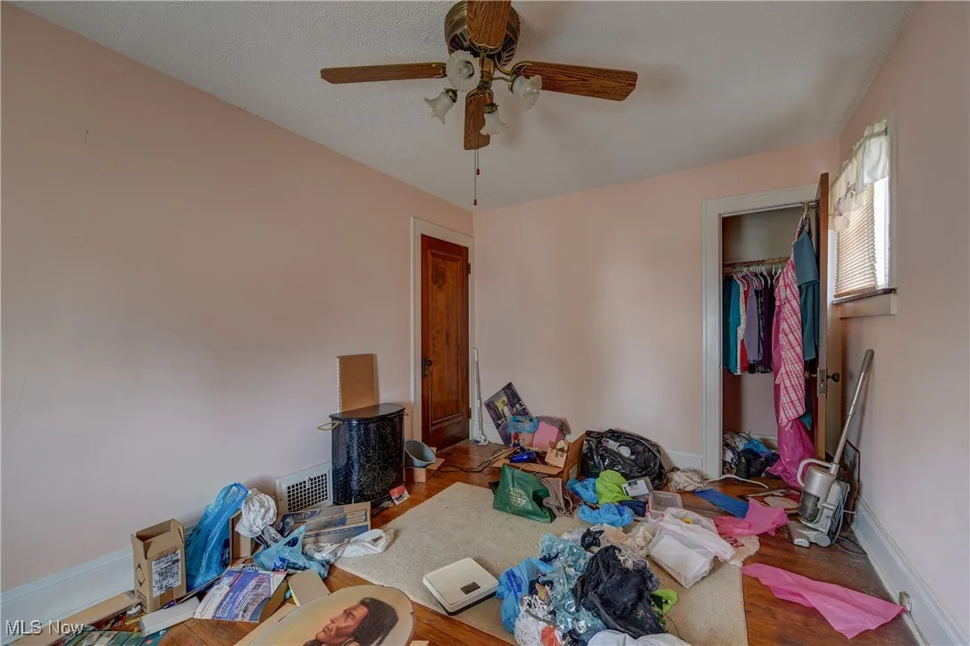 Bedroom featuring a closet, a ceiling fan, and wood finished floors