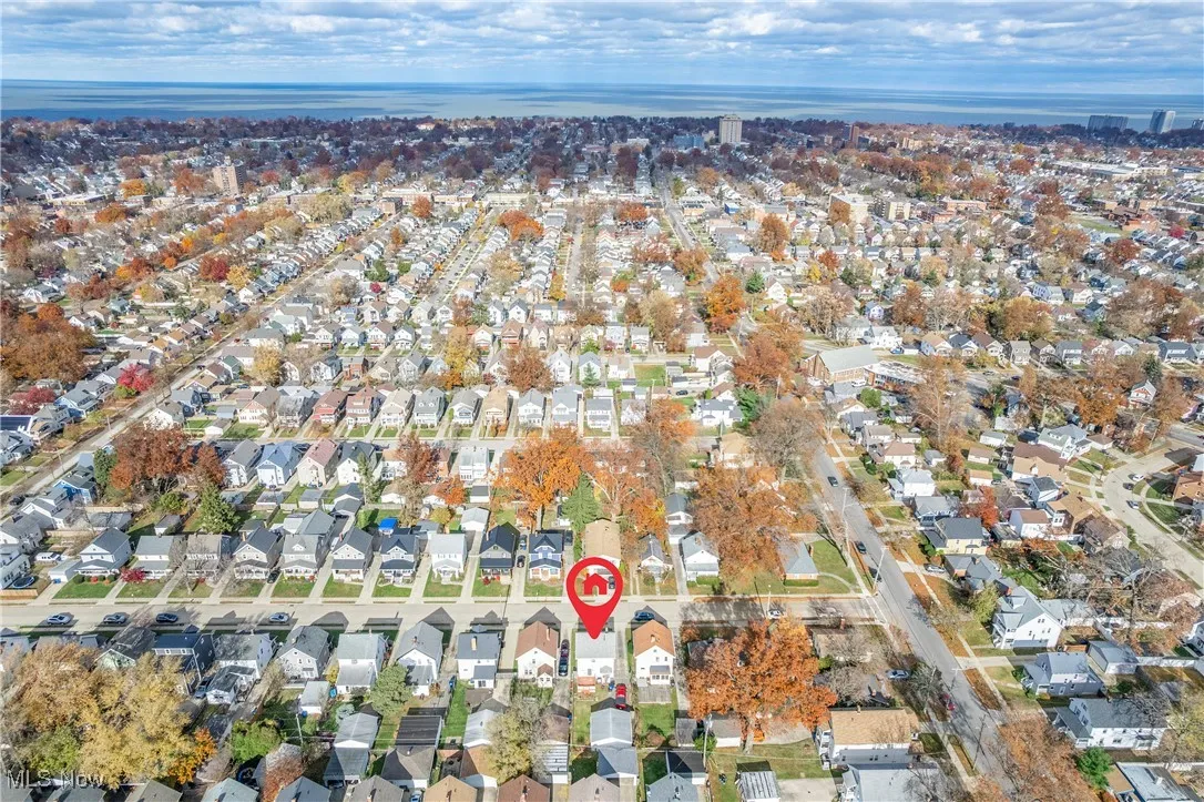 Aerial view of property's location with nearby suburban area and a nearby body of water