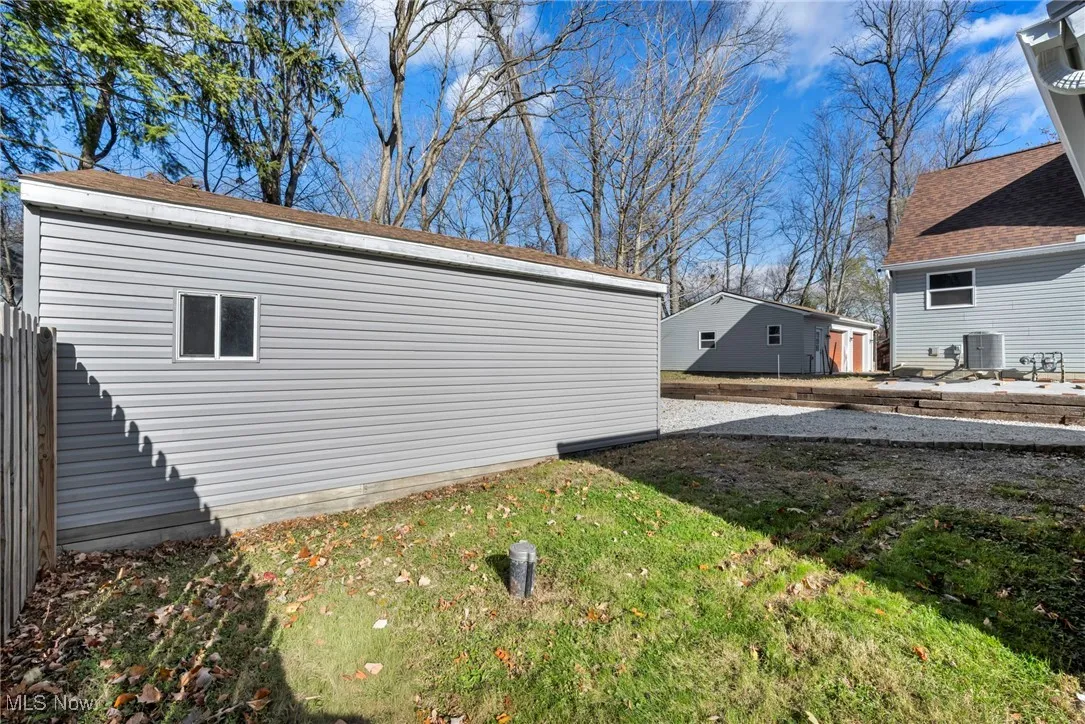 View of home's exterior with a lawn and a central air condition unit