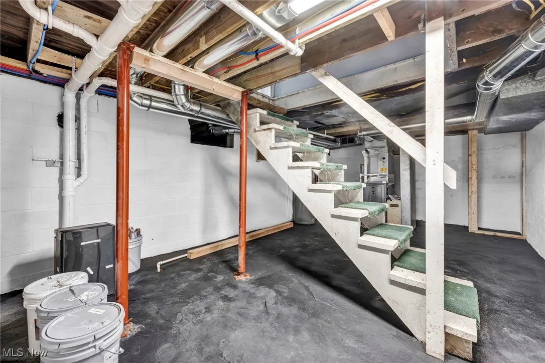 Unfinished below grade area featuring stairway