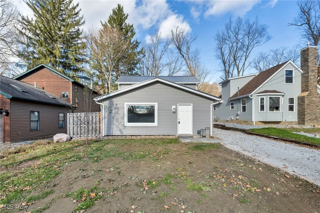 View of front facade with a patio and a metal roof