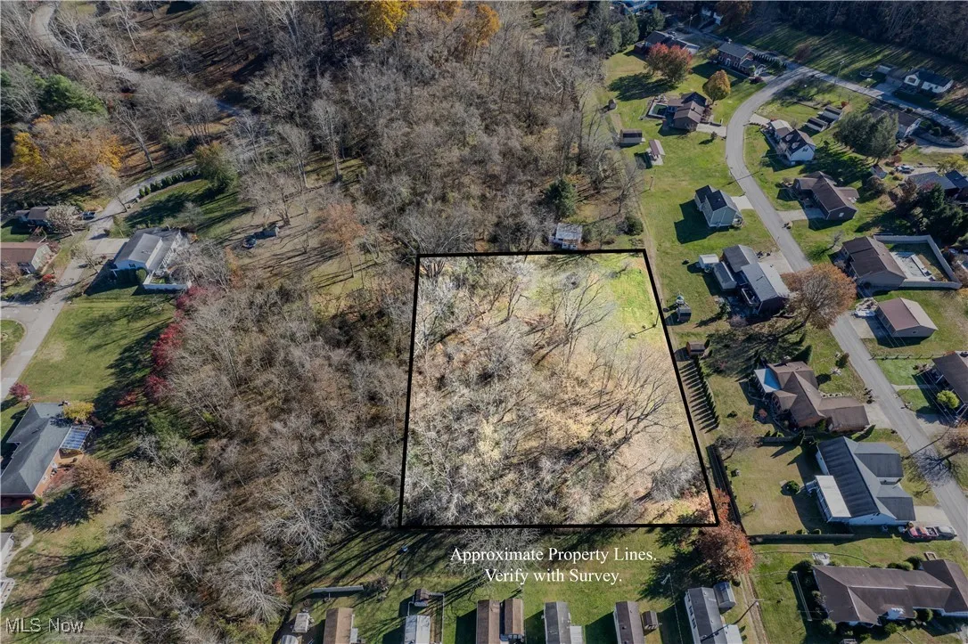 Aerial view of property and surrounding area with property parcel outlined