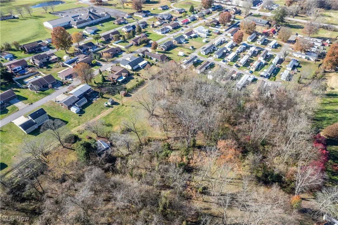 Aerial overview of property's location featuring nearby suburban area