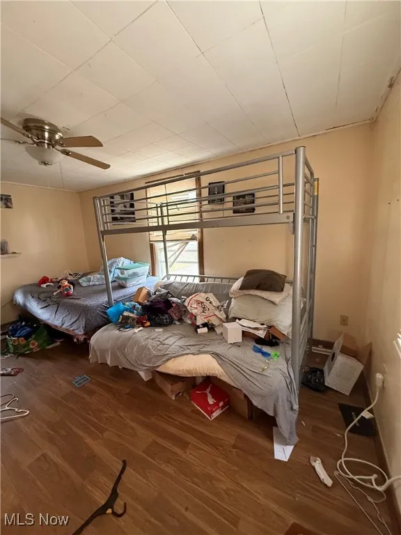 Bedroom with wood finished floors and a ceiling fan