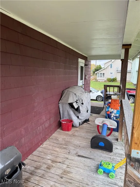 Wooden porch with a grill