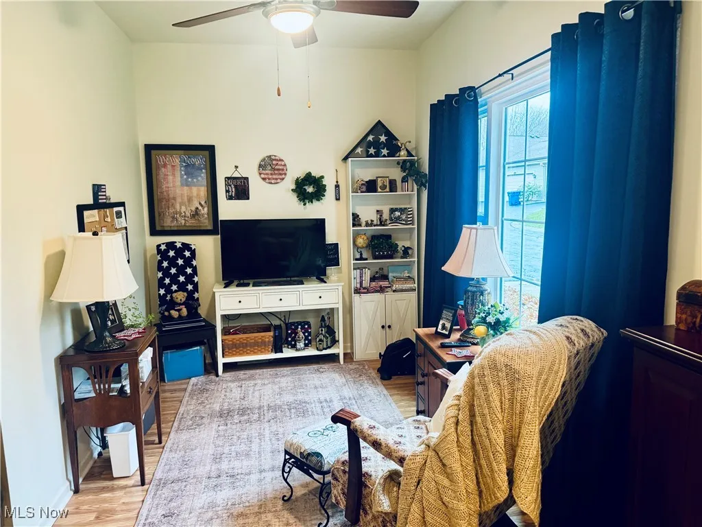 Living room with wood finished floors and ceiling fan