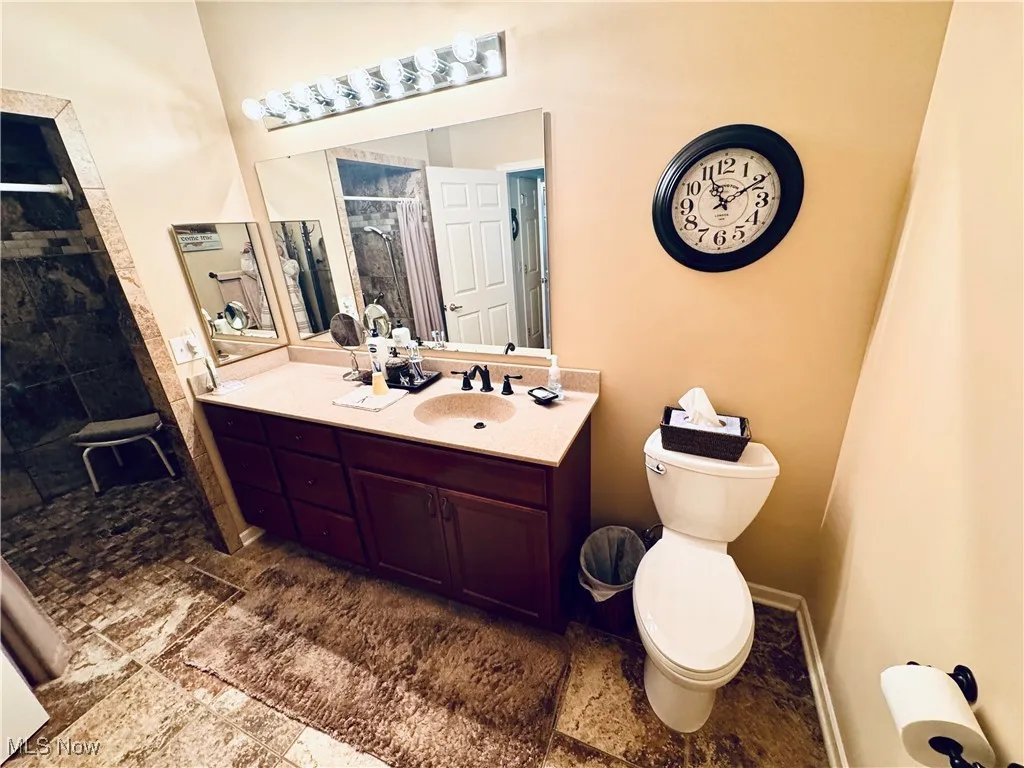 Bathroom featuring a shower stall and vanity
