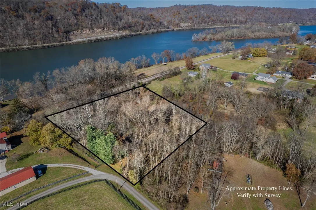 Aerial overview of property's location featuring a heavily wooded area and property parcel outlined