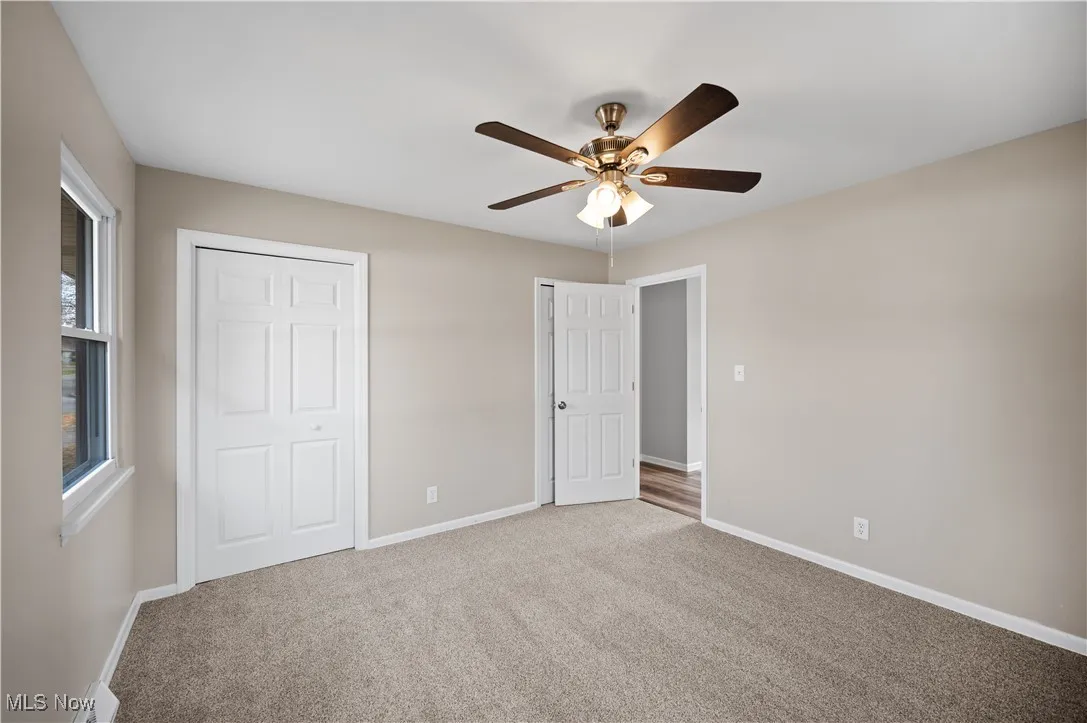 Unfurnished bedroom featuring carpet and ceiling fan
