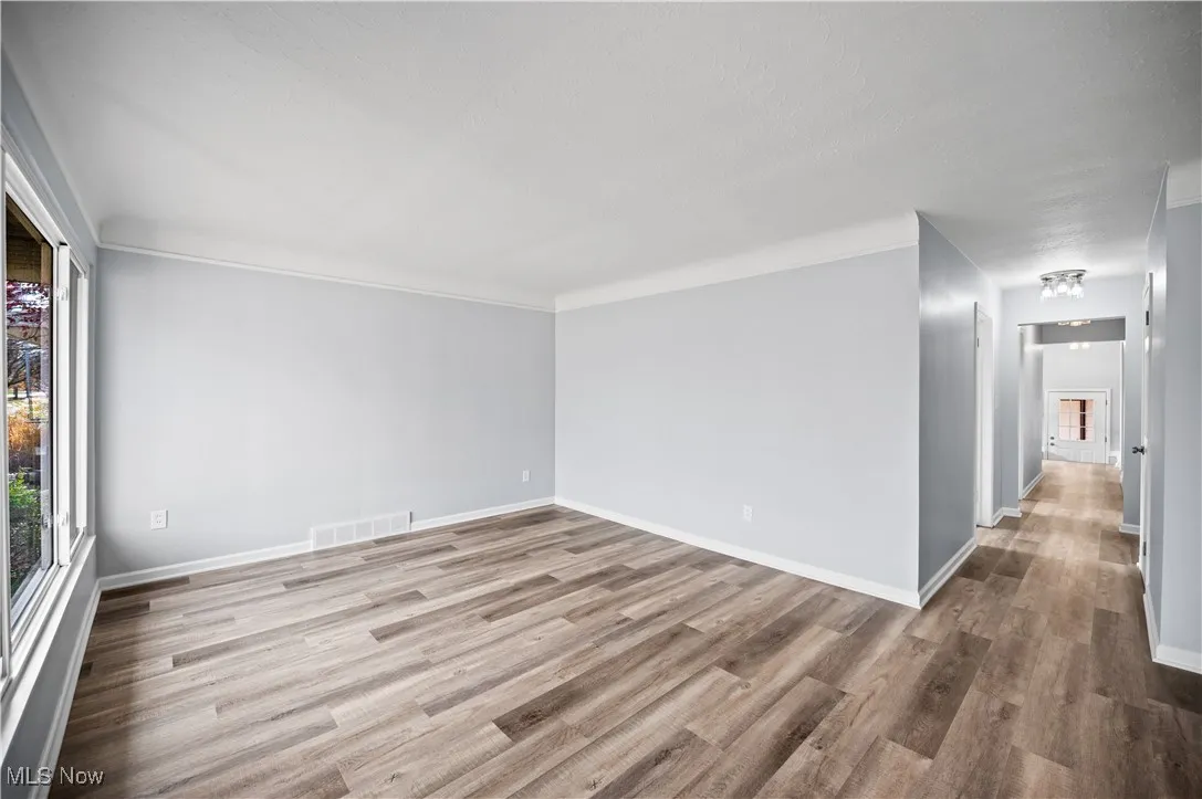 Empty room featuring light wood finished floors and baseboards
