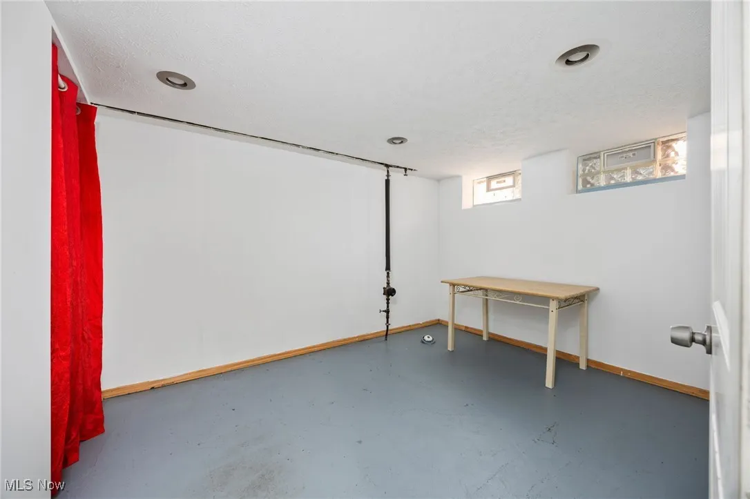 Basement featuring a textured ceiling
