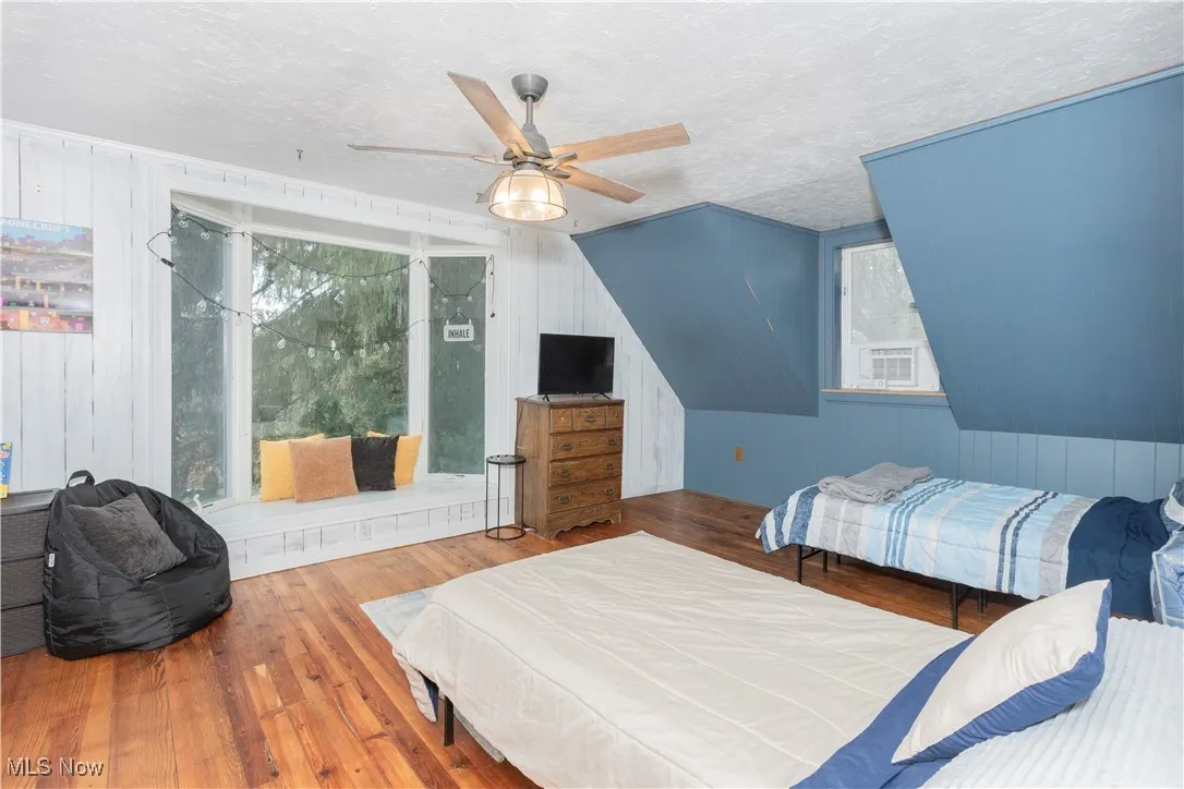 Bright bedroom with great closet space. Refinished wooden floors and ceiling fan.