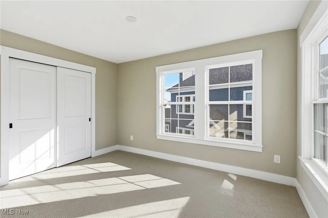 Third bedroom featuring light-colored carpet