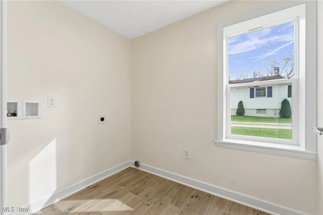 Laundry room with light wood-style floors, washer hookup, and hookup for an electric dryer