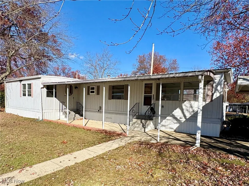 View of front of home with a front lawn and covered porch