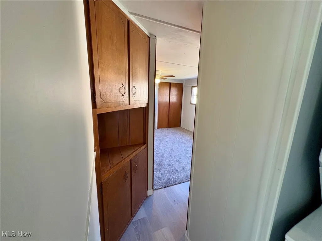 Hall with light wood-style flooring