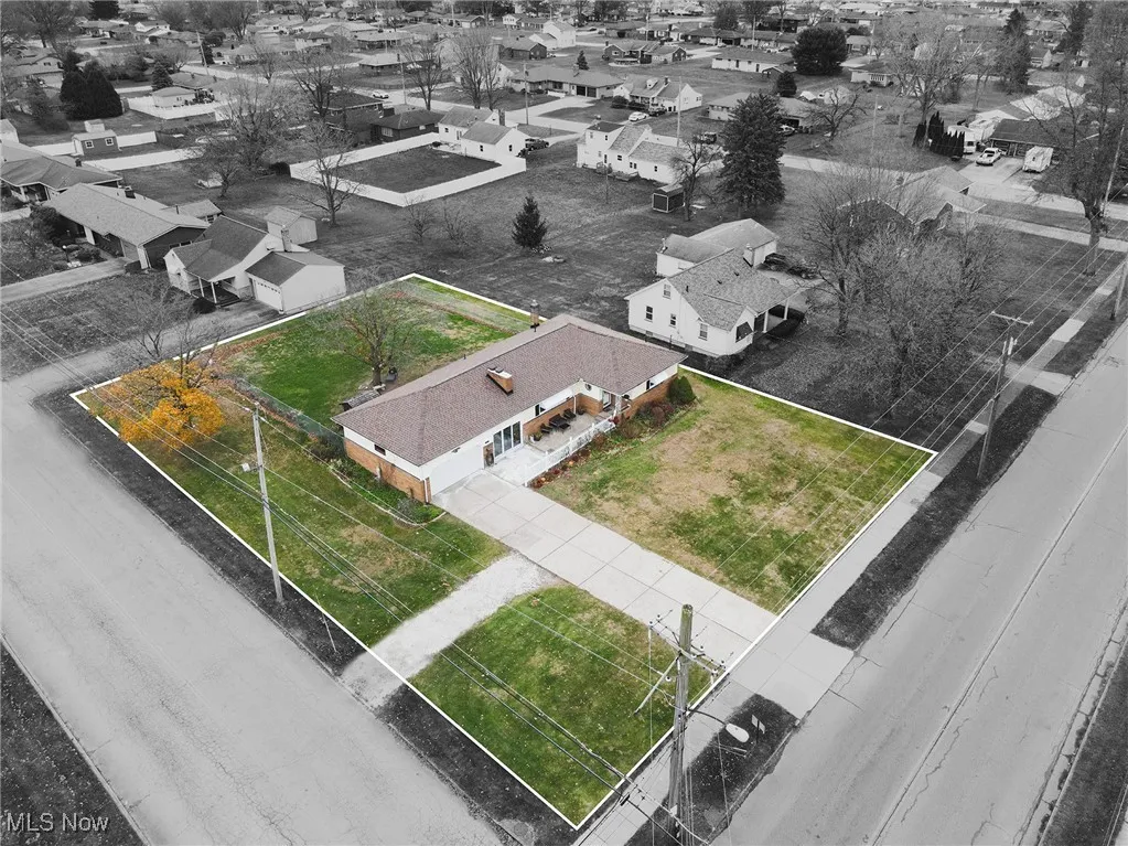 Aerial perspective of suburban area featuring property boundaries highlighted