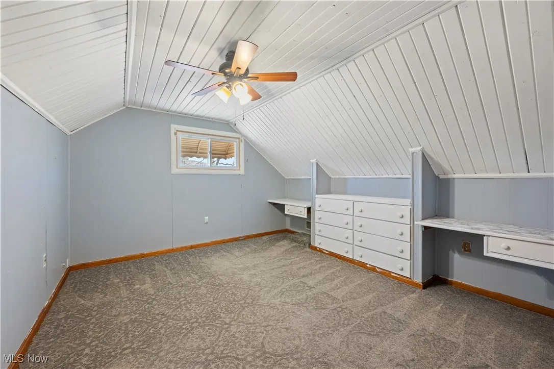 Bonus room featuring carpet floors, lofted ceiling, wood ceiling, and ceiling fan