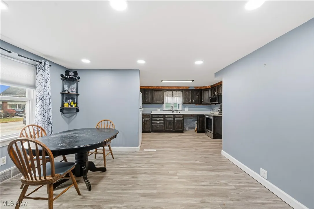 Dining area with light wood-style floors, recessed lighting, and healthy amount of natural light