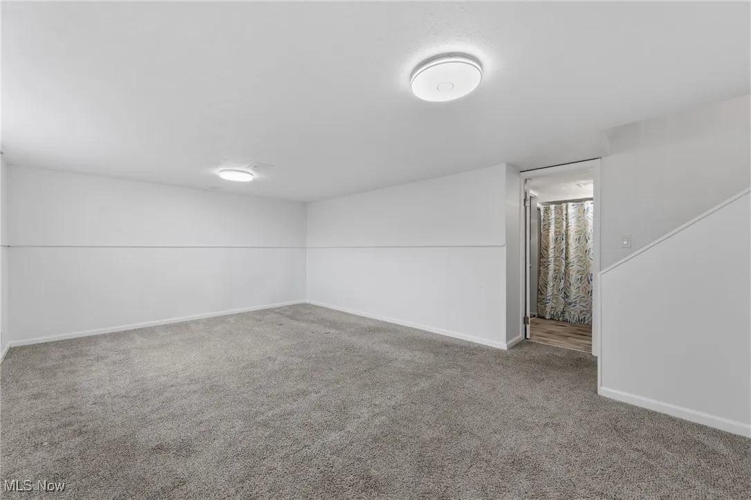 Unfurnished room featuring baseboards and carpet floors