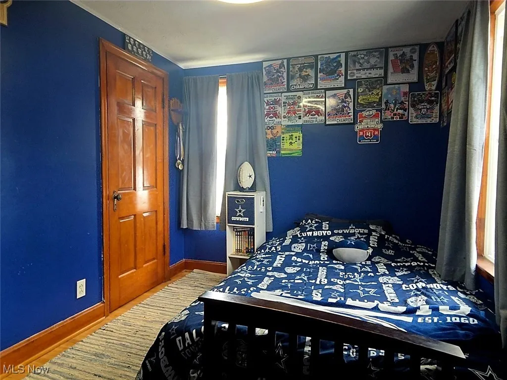Bedroom with light wood-style flooring and baseboards