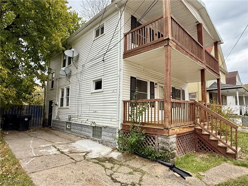 View of home's exterior featuring a porch and a balcony