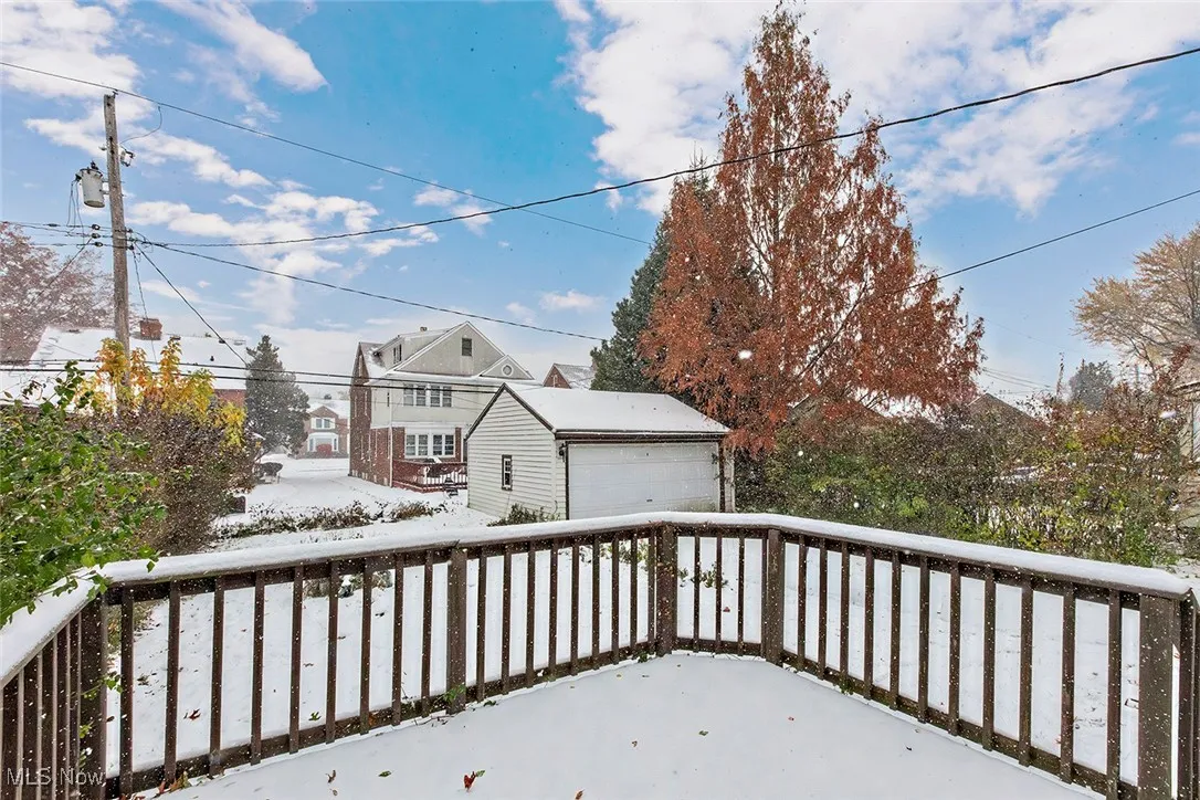 Wooden deck featuring a detached garage