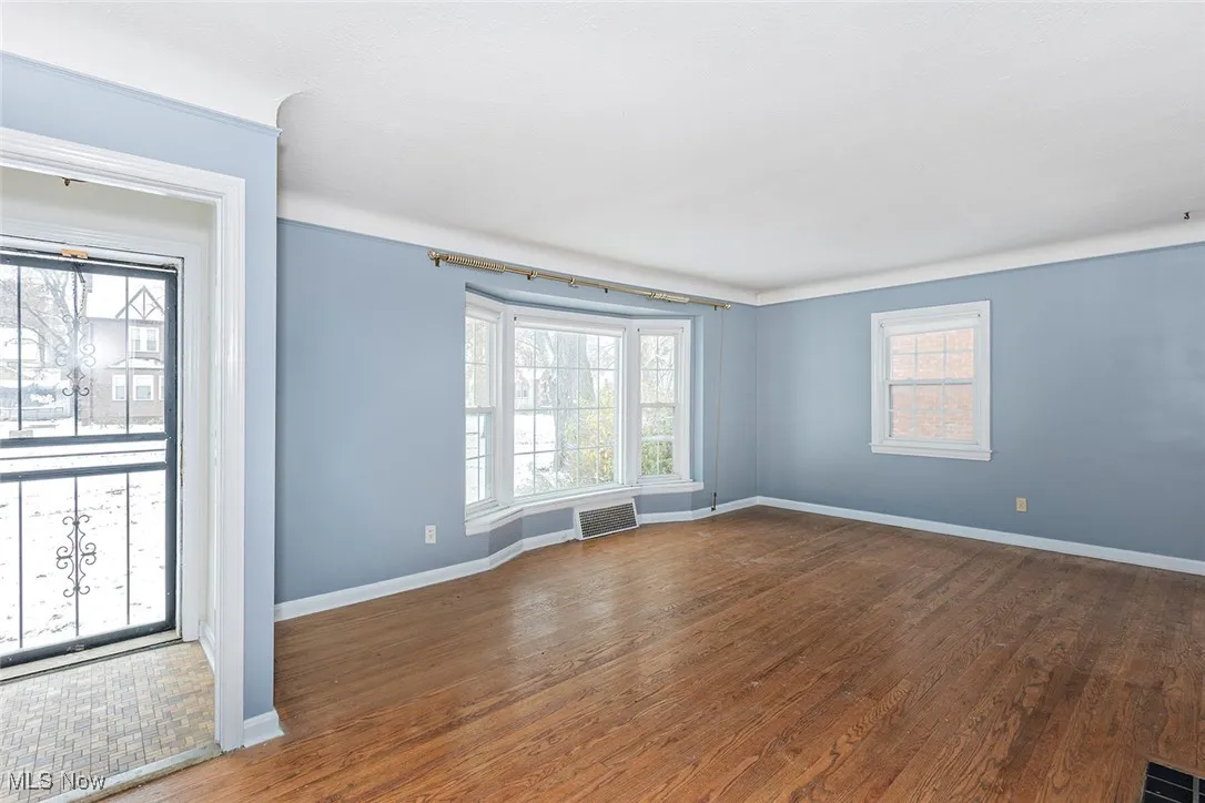 Unfurnished room featuring wood finished floors and baseboards