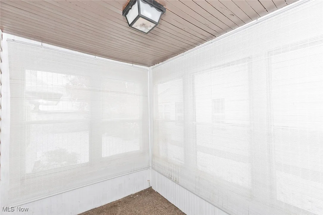 Detailed view of carpet and wood ceiling