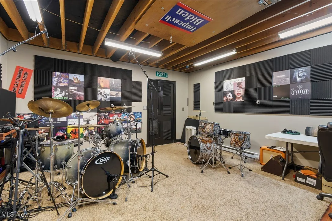 Recreation room featuring radiator heating unit and a baseboard radiator