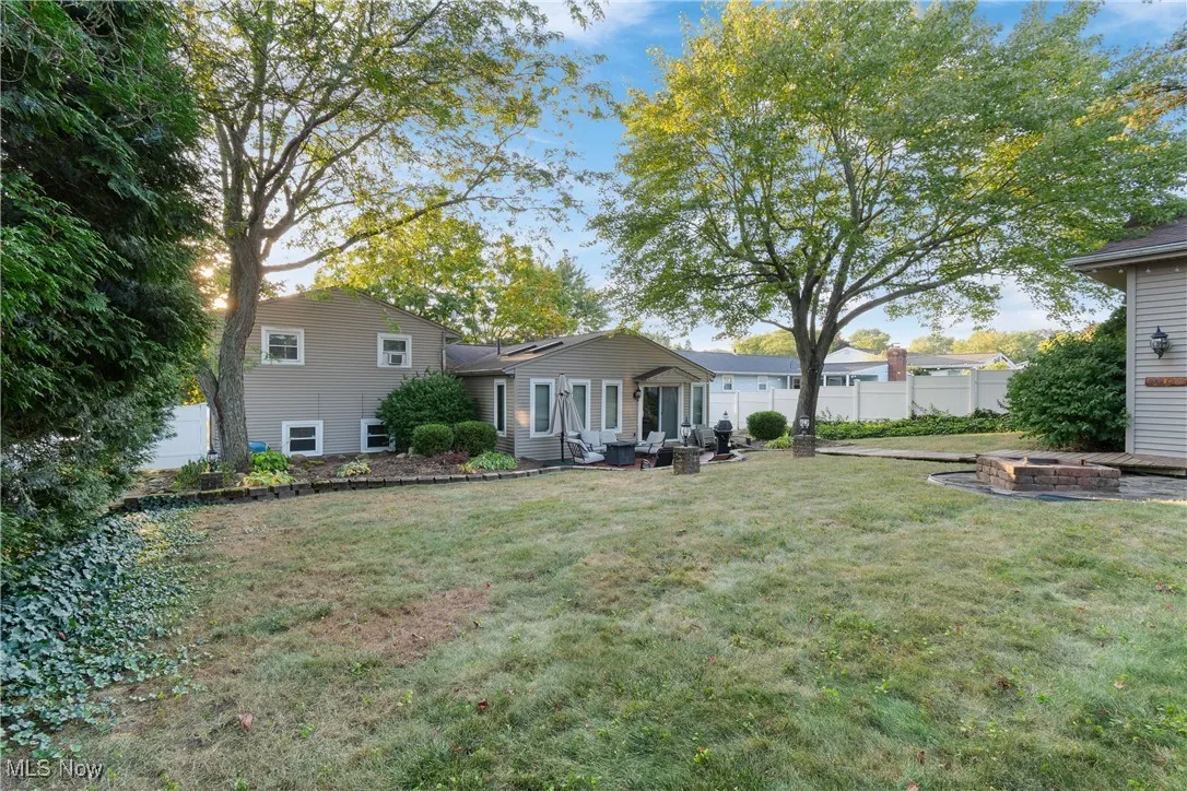 Back of property featuring a patio area and an outdoor fire pit