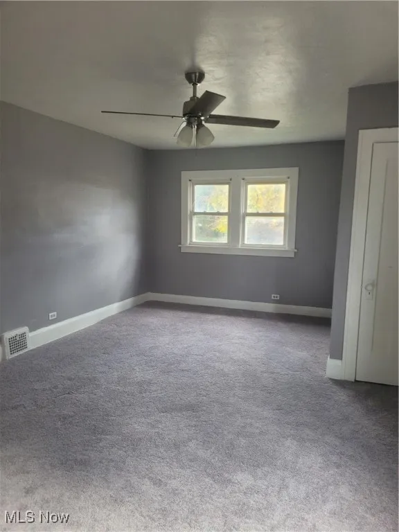 Unfurnished bedroom with carpet and ceiling fan