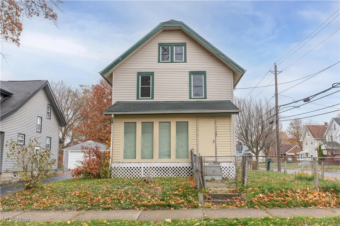 American foursquare style home with a gate