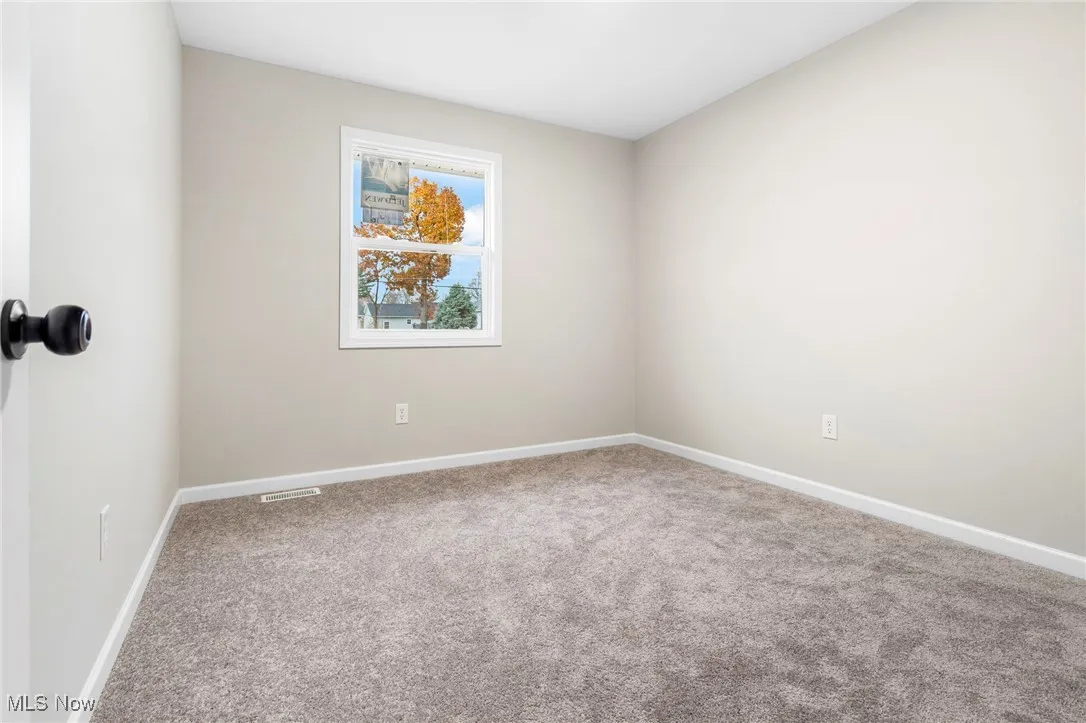Unfurnished room featuring carpet floors and baseboards