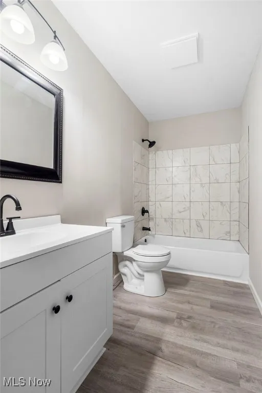 Full bath featuring shower / bath combination, light wood-type flooring, and vanity
