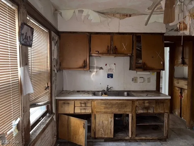 Kitchen with light countertops and brown cabinetry