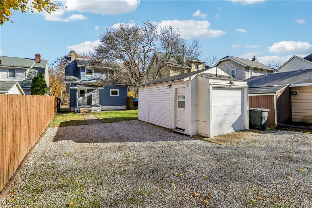 View of 1 car detached garage and driveway parking behind the home