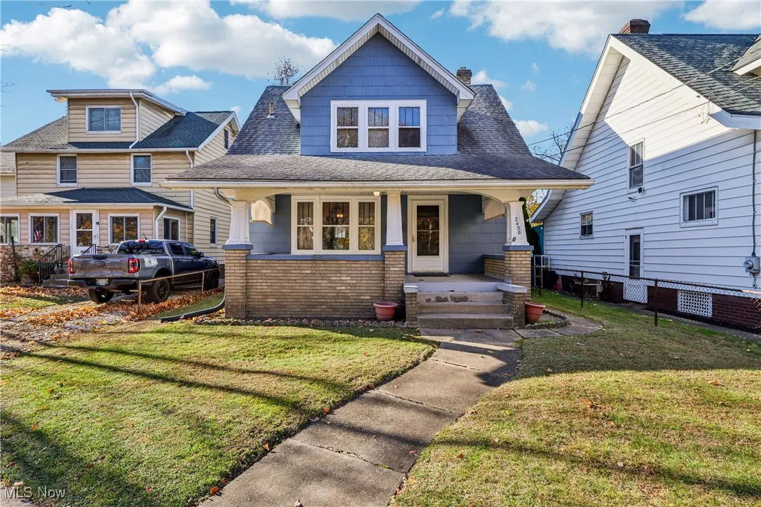 Front of the property with a porch, sidewalk and yard