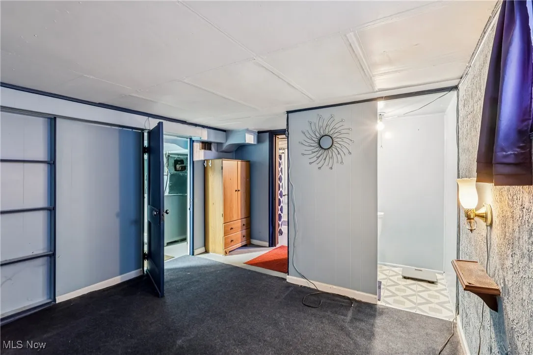 Lower level unfurnished bedroom featuring carpet flooring