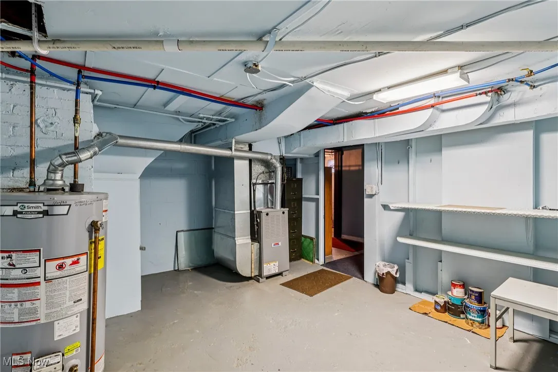 Another view of the lower level showing furnace and water heater