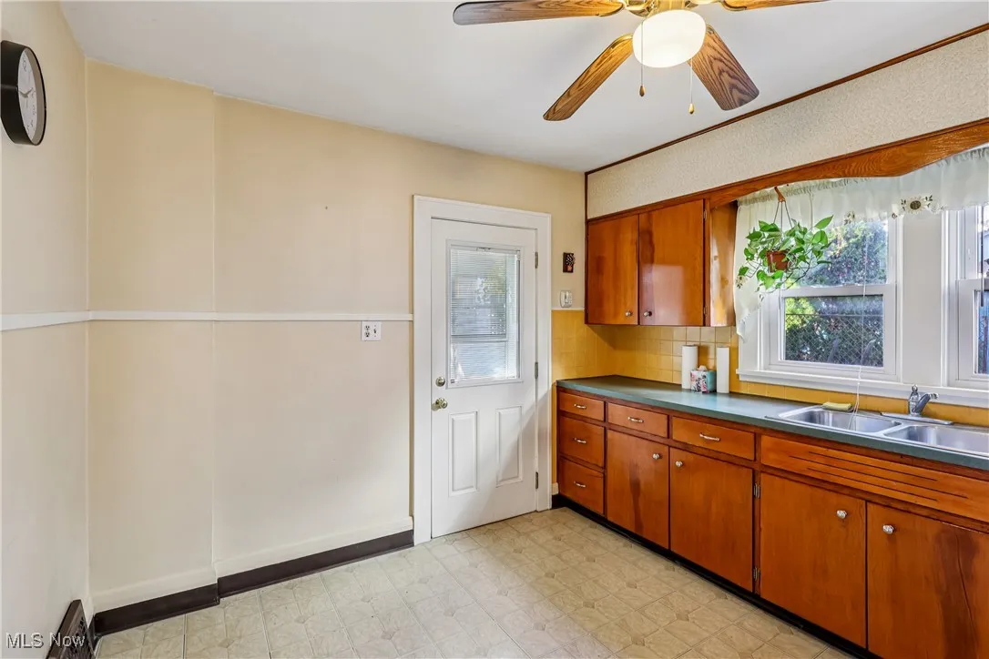 Another view of the kitchen showing back door entry