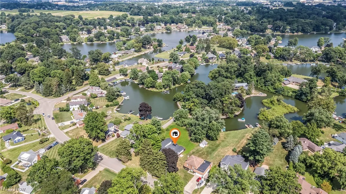 Aerial overview of property's location with a large body of water and nearby suburban area