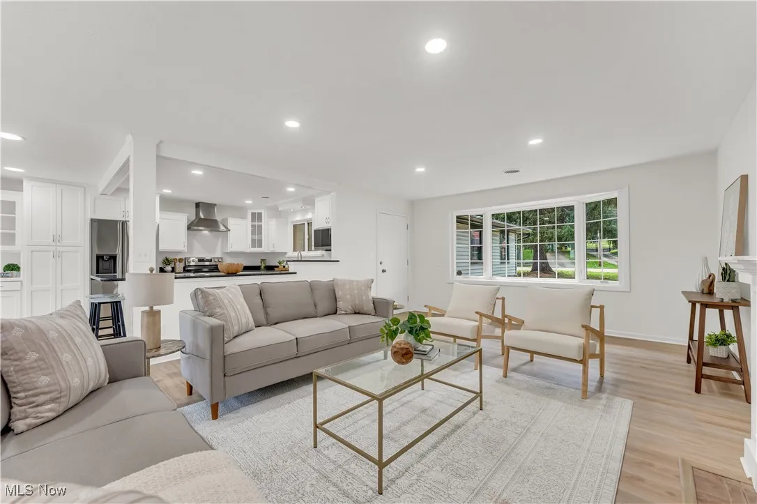 Living room with recessed lighting and light wood-type flooring