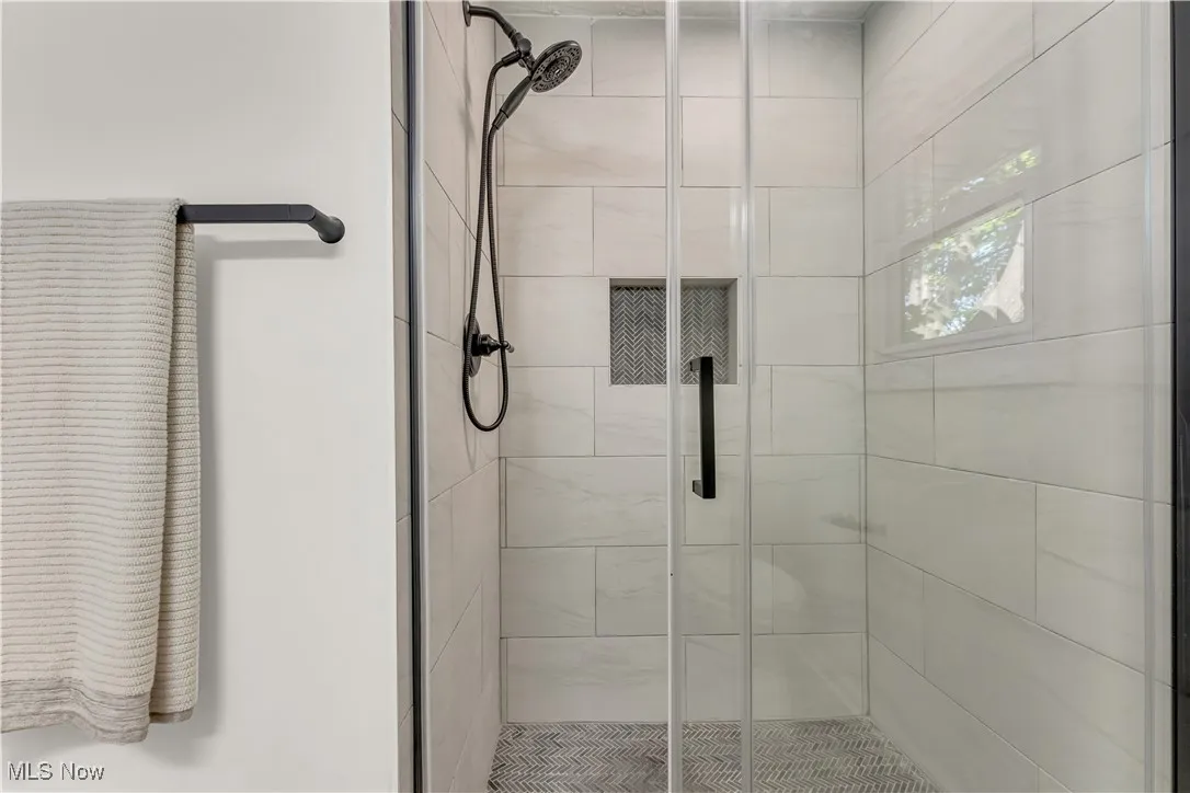 Full bathroom featuring a shower stall