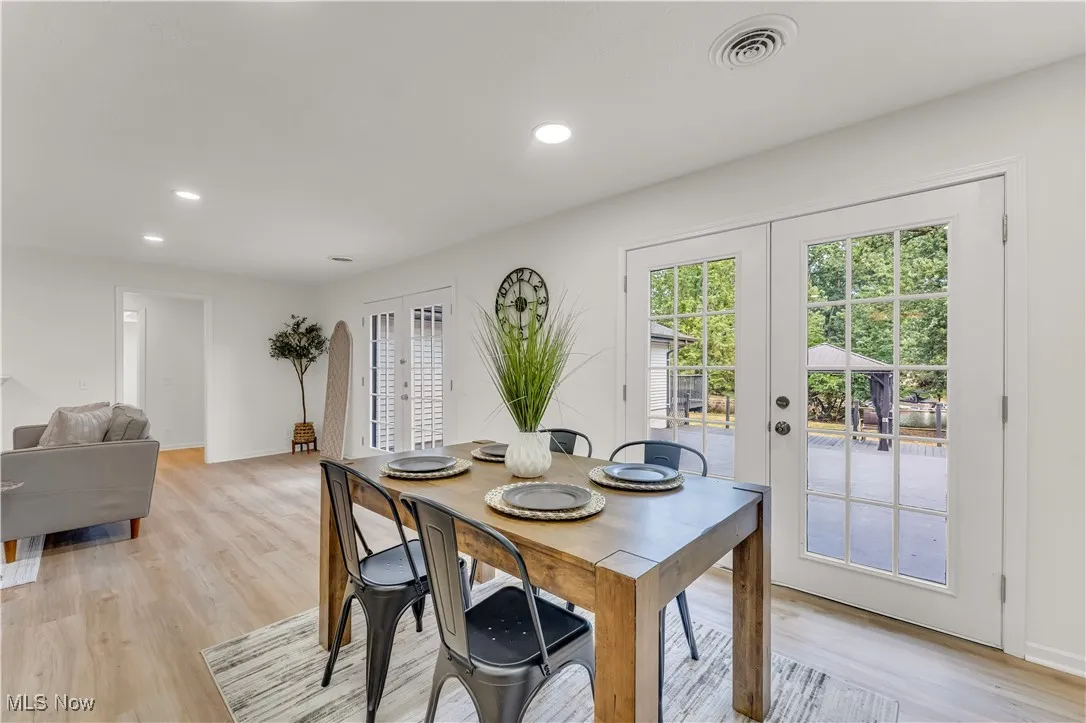 Dining room featuring french doors, light wood finished floors, and recessed lighting