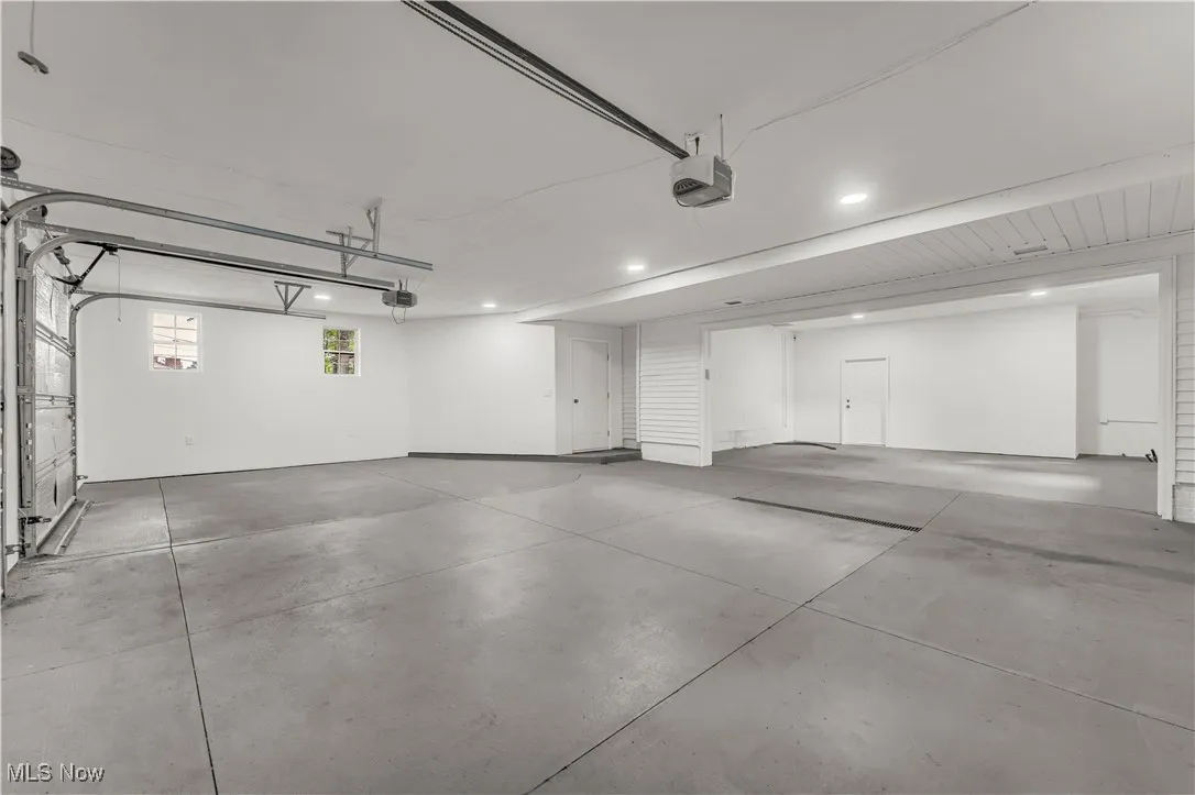 Garage featuring a garage door opener and recessed lighting